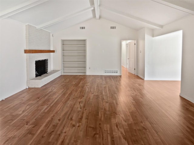 unfurnished living room with wood-type flooring, a brick fireplace, vaulted ceiling with beams, and built in features