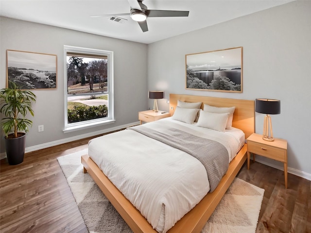 bedroom with dark wood-type flooring and ceiling fan