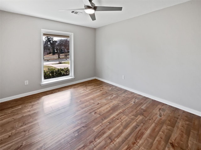 spare room featuring wood-type flooring and ceiling fan