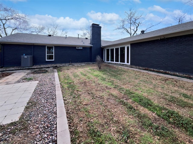 rear view of property featuring central AC