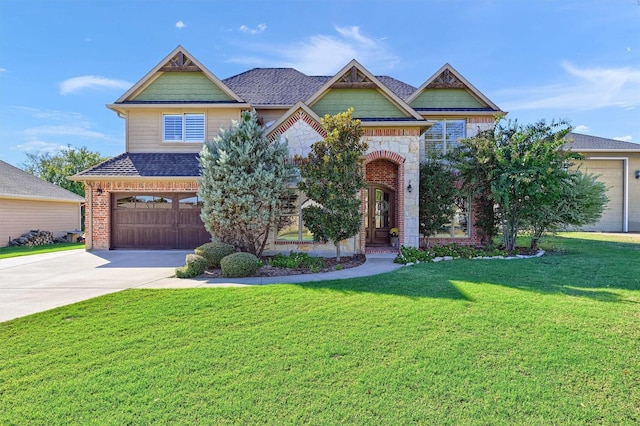 craftsman house with a garage and a front lawn