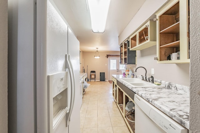 kitchen featuring sink, white appliances, decorative light fixtures, and light tile patterned flooring