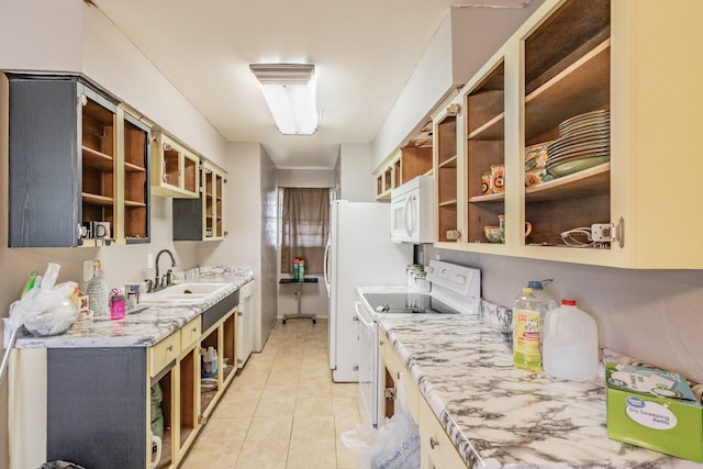 kitchen featuring sink, white appliances, light stone countertops, and light tile patterned flooring