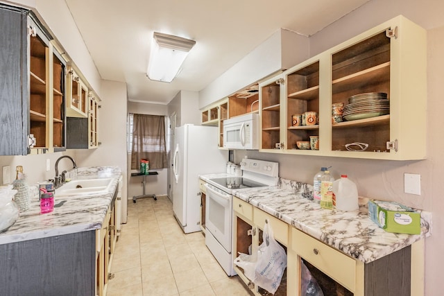 kitchen featuring sink, light tile patterned floors, and white appliances