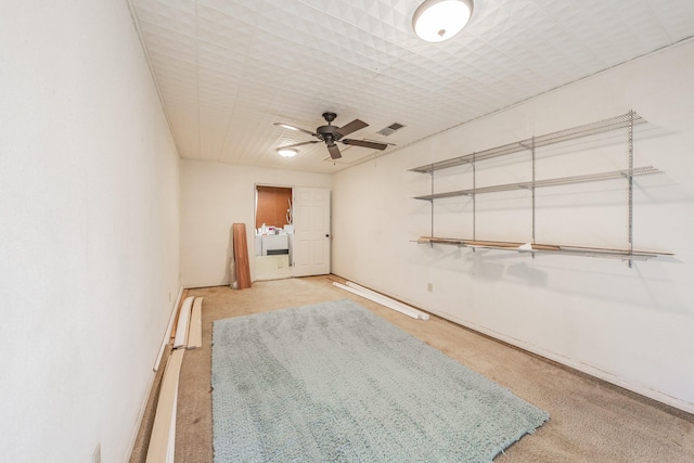 empty room featuring a baseboard heating unit and ceiling fan