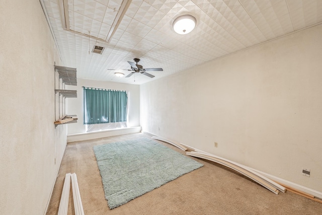 spare room with light colored carpet and ceiling fan