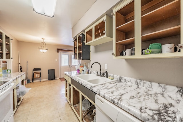 kitchen featuring white appliances, sink, hanging light fixtures, and light tile patterned floors