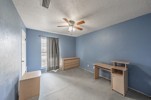 office area featuring light carpet, a textured ceiling, and ceiling fan