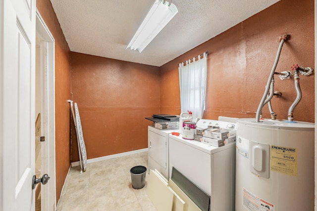 washroom with a textured ceiling, electric water heater, and washing machine and clothes dryer