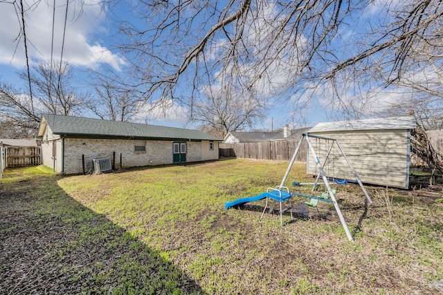 view of yard featuring a shed and central air condition unit