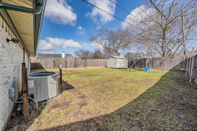 view of yard with central AC unit and a storage unit