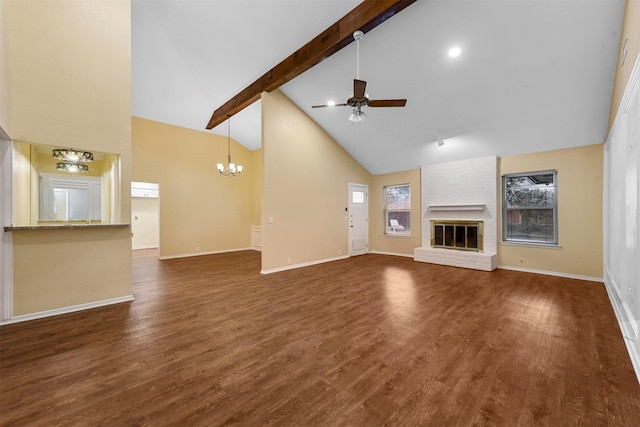 unfurnished living room featuring beamed ceiling, ceiling fan with notable chandelier, dark wood-type flooring, and a brick fireplace