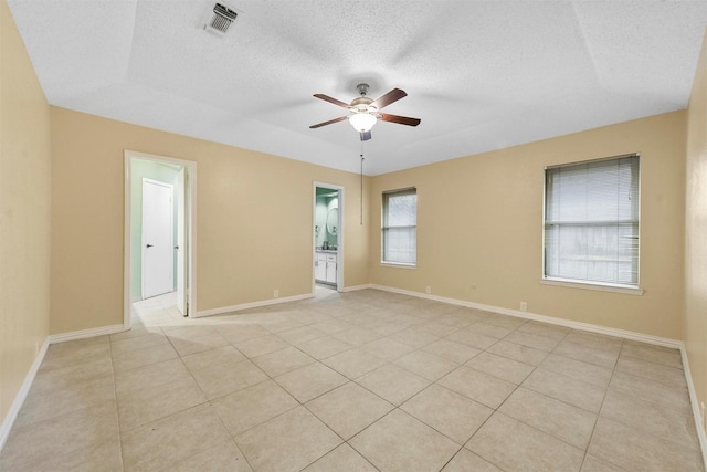 unfurnished room featuring light tile patterned flooring, a textured ceiling, and ceiling fan