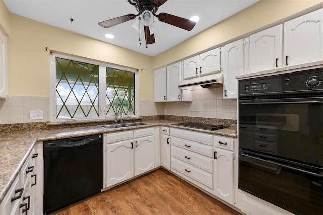 kitchen with white cabinetry, sink, black appliances, and hardwood / wood-style floors