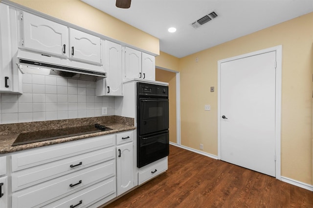 kitchen with dark hardwood / wood-style flooring, backsplash, black appliances, and white cabinets