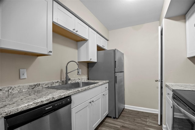 kitchen with appliances with stainless steel finishes, sink, and white cabinets