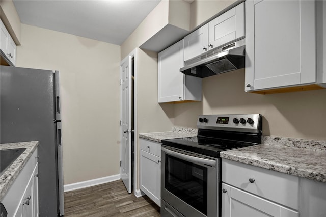 kitchen featuring stainless steel appliances, dark hardwood / wood-style floors, light stone countertops, and white cabinets