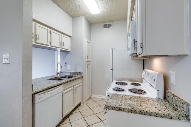 kitchen with sink, a textured ceiling, white appliances, light stone countertops, and white cabinets