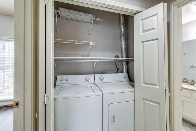 laundry area featuring separate washer and dryer and sink