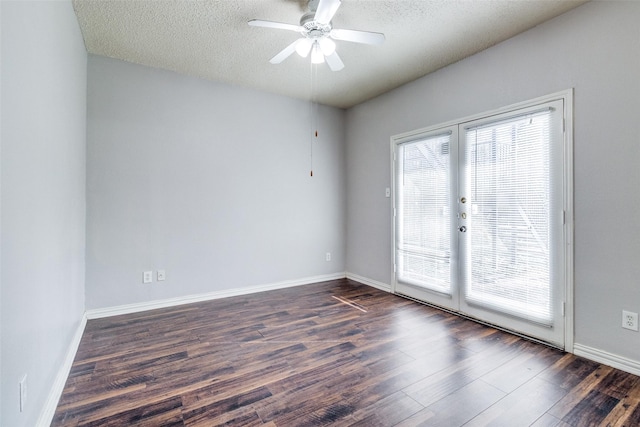 spare room featuring dark wood-type flooring, ceiling fan, and a textured ceiling