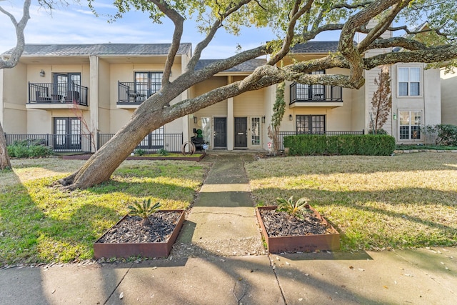 view of front of home with a front yard and french doors