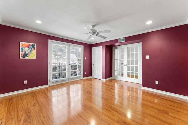 spare room featuring ornamental molding, hardwood / wood-style floors, ceiling fan, and french doors