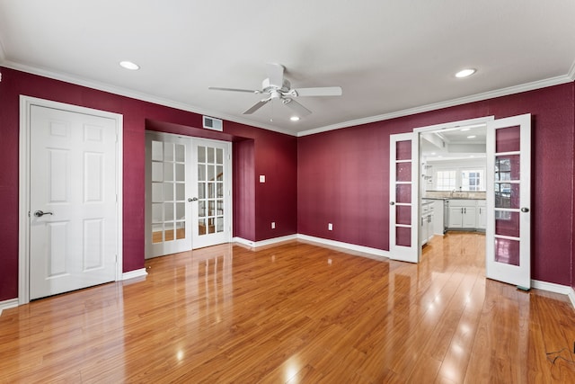 unfurnished room featuring sink, ornamental molding, ceiling fan, light wood-type flooring, and french doors