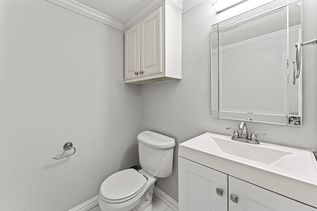 bathroom with vanity, crown molding, and toilet