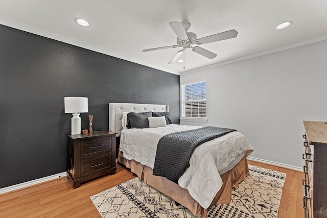 bedroom featuring ornamental molding, ceiling fan, and light hardwood / wood-style floors