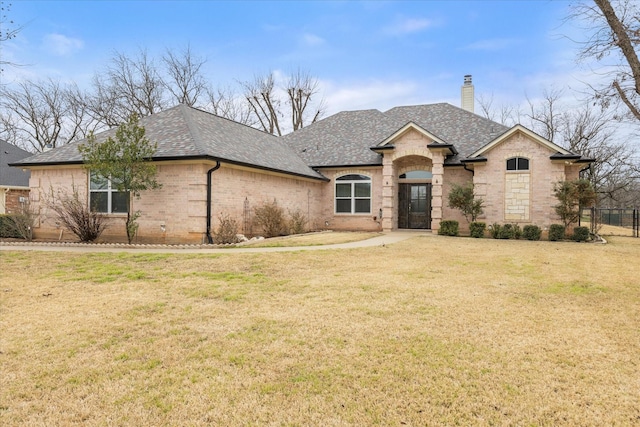 french country style house with a front lawn