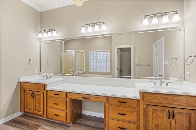 bathroom with hardwood / wood-style flooring, ornamental molding, a shower with door, and vanity