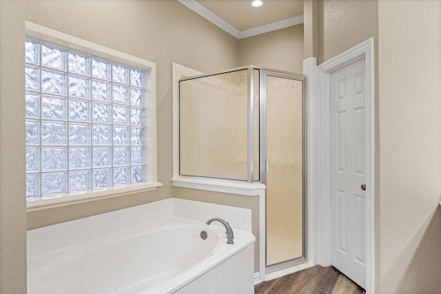 bathroom with independent shower and bath, crown molding, and wood-type flooring