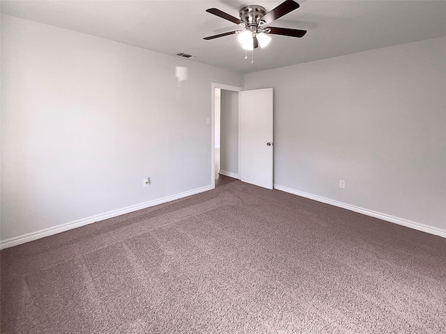 unfurnished room featuring dark carpet and ceiling fan