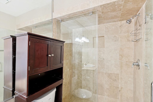 bathroom featuring a shower with shower door