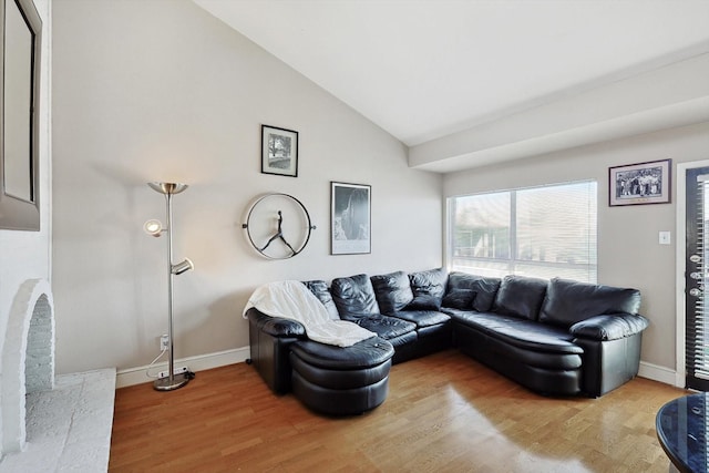 living room with vaulted ceiling and wood-type flooring