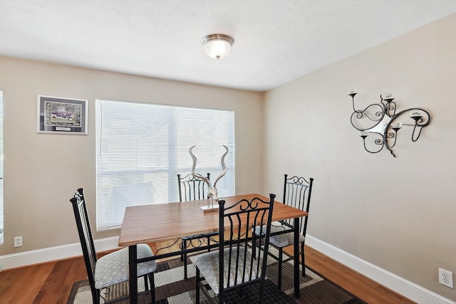 dining space with hardwood / wood-style flooring