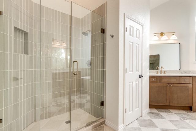 bathroom featuring vanity and a shower with shower door