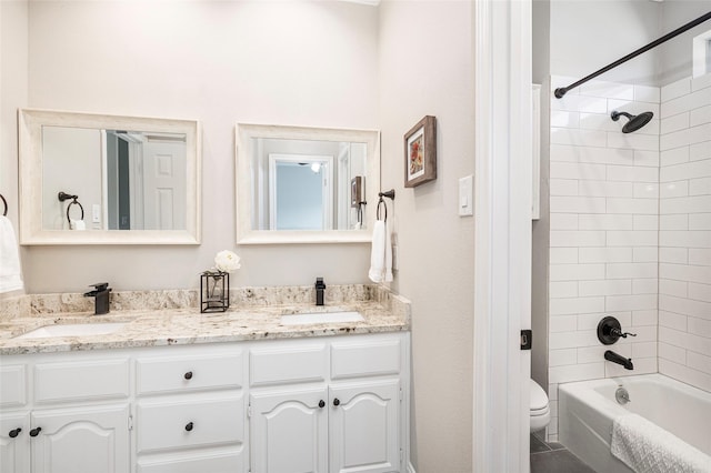 full bathroom featuring vanity, toilet, and tiled shower / bath combo