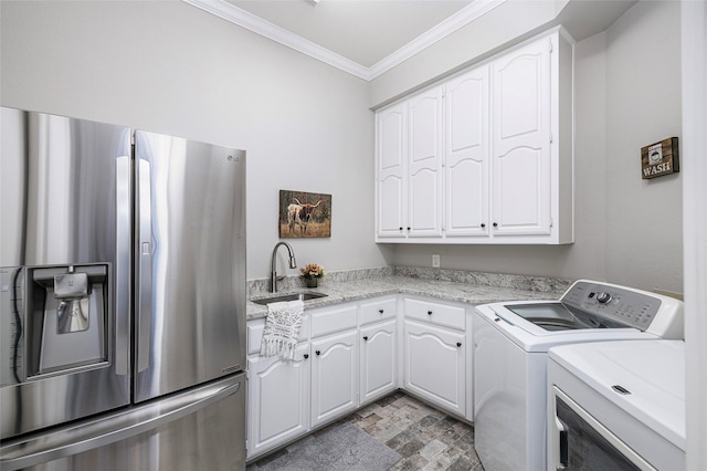 laundry room featuring sink, crown molding, and washing machine and dryer