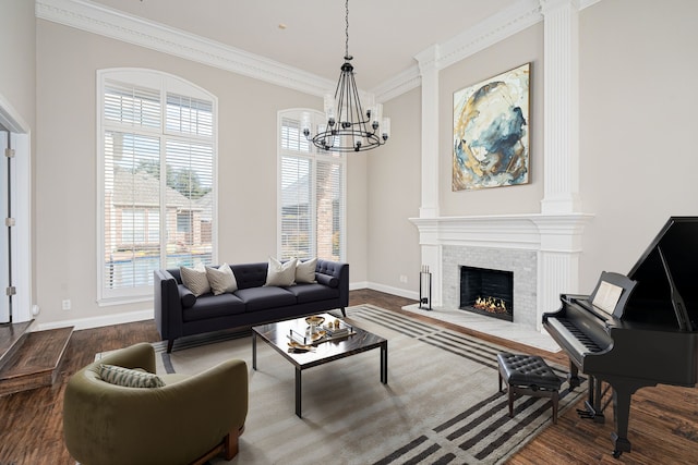 living room with hardwood / wood-style flooring, ornamental molding, and a chandelier