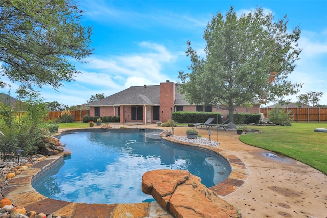 view of swimming pool with a yard and a patio