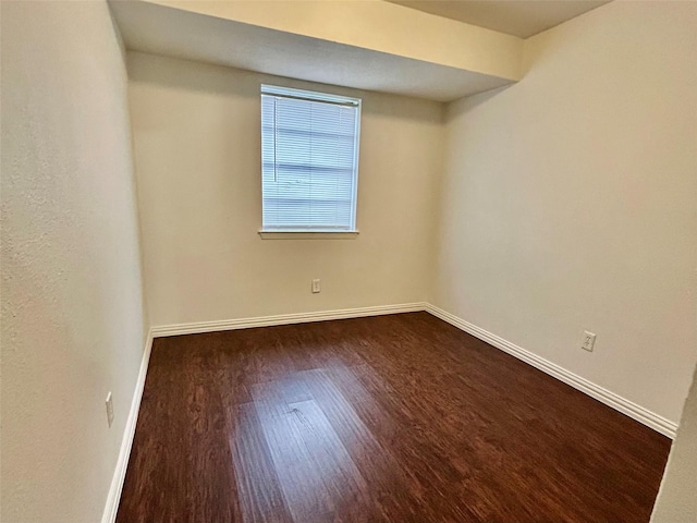 unfurnished room featuring dark wood-type flooring