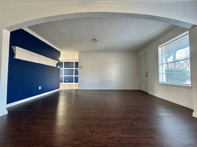 empty room featuring crown molding and dark wood-type flooring