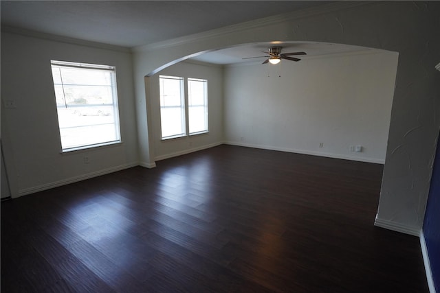 spare room with dark hardwood / wood-style flooring, ornamental molding, and ceiling fan