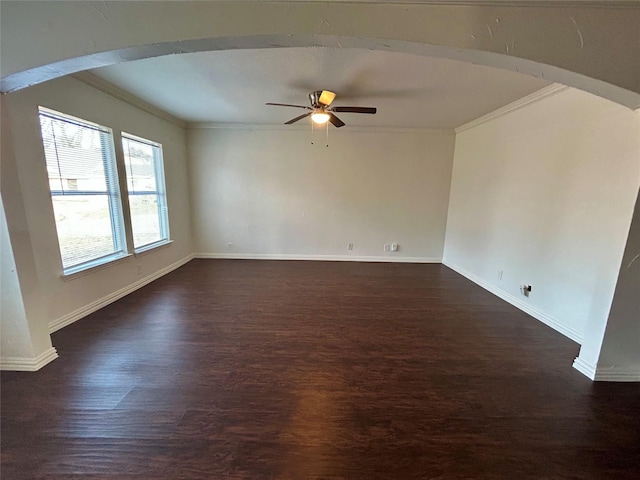 empty room with ornamental molding, dark hardwood / wood-style floors, and ceiling fan