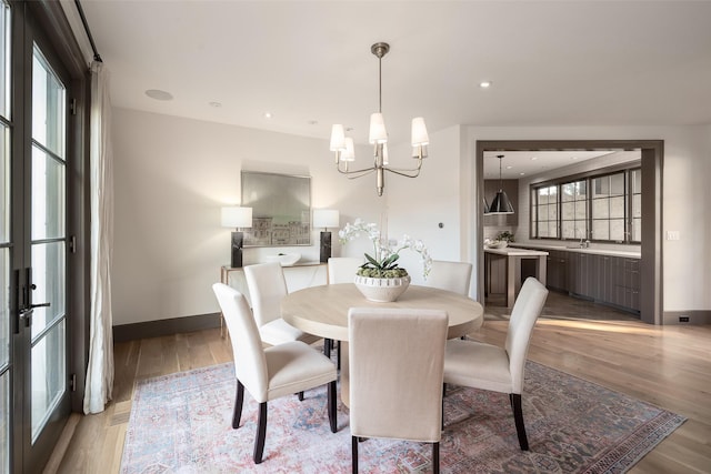 dining room featuring a chandelier and light wood-type flooring