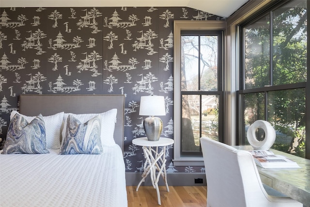 bedroom with hardwood / wood-style flooring and lofted ceiling