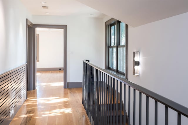 corridor with light hardwood / wood-style floors