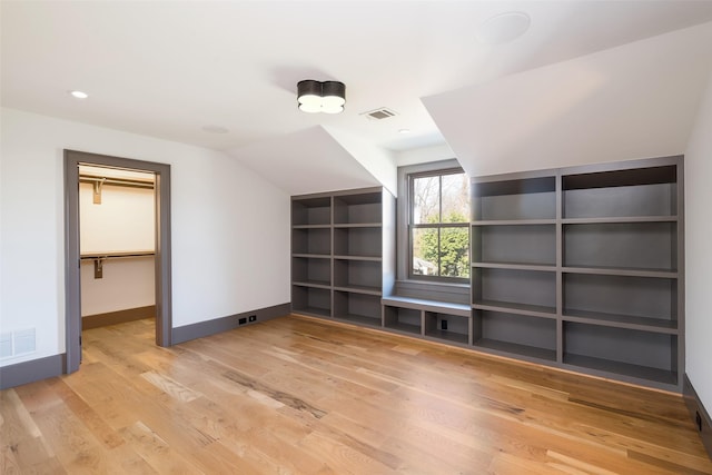 bonus room featuring lofted ceiling and wood-type flooring