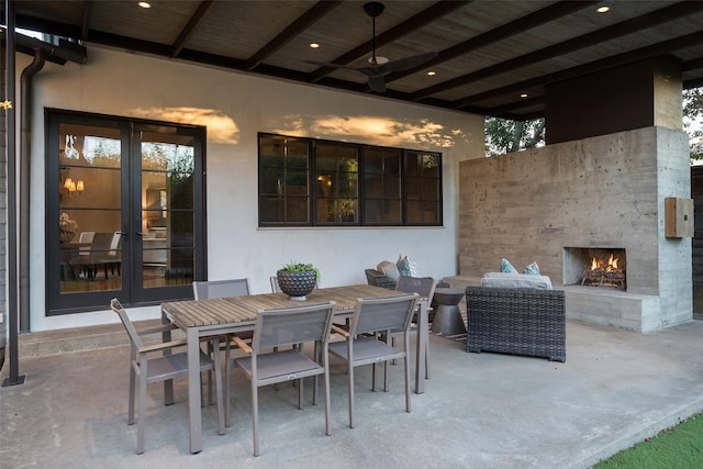 view of patio with french doors, ceiling fan, and exterior fireplace